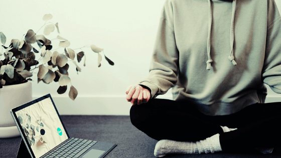 Picture of man meditating by laptop to head blog post How to Meditate with 9 Absolutely Free Creative-Tech Tools during National Meditation Month.