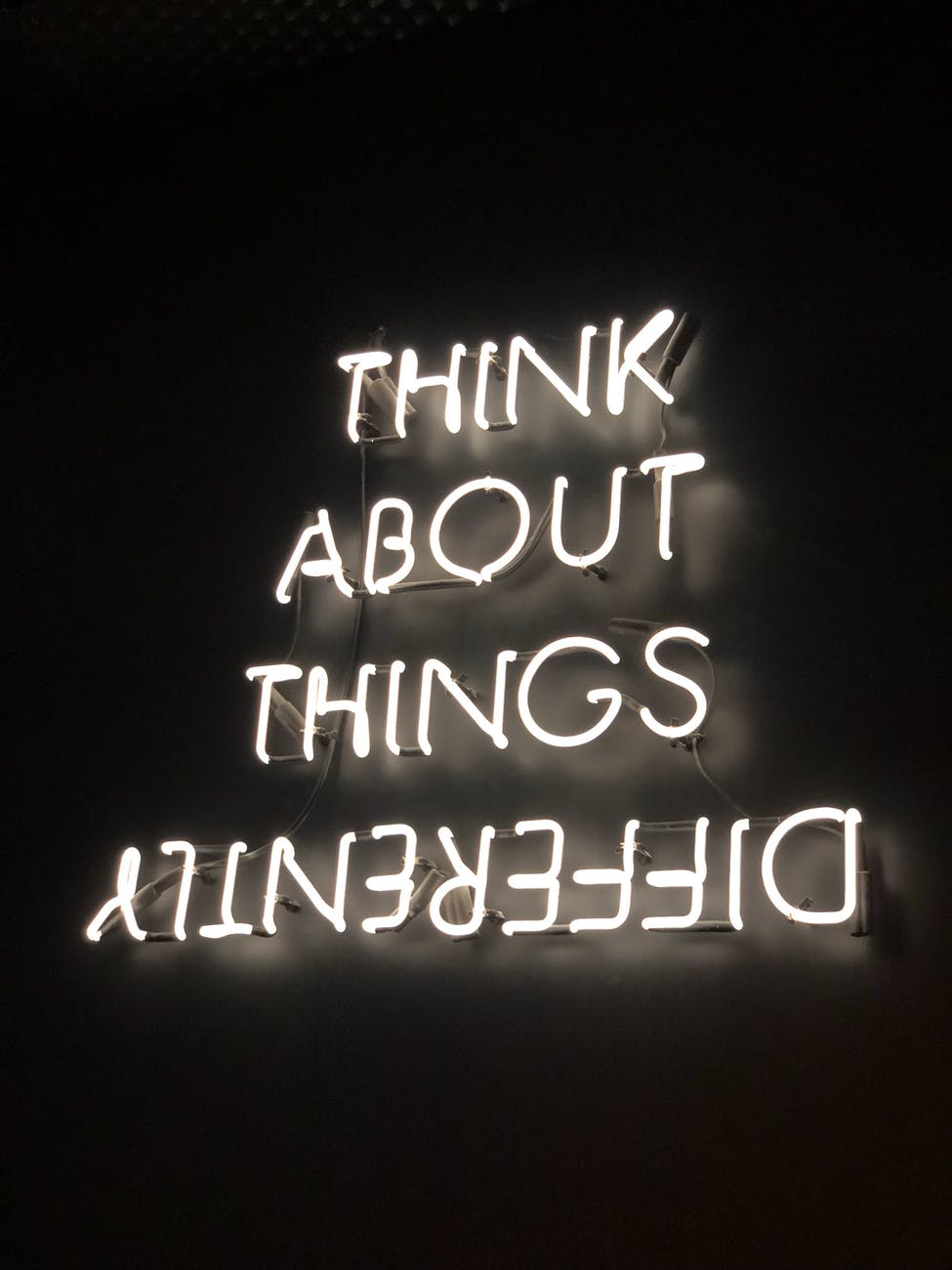 neon signage which shows the last word upside down to talk about different lenses of perspective for wrting your life story.